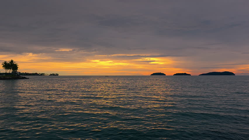 Golden Hues Across Cloudy Sunset Sky Over The Sea In Kota Kinabalu, Sabah, Malaysia. wide static shot