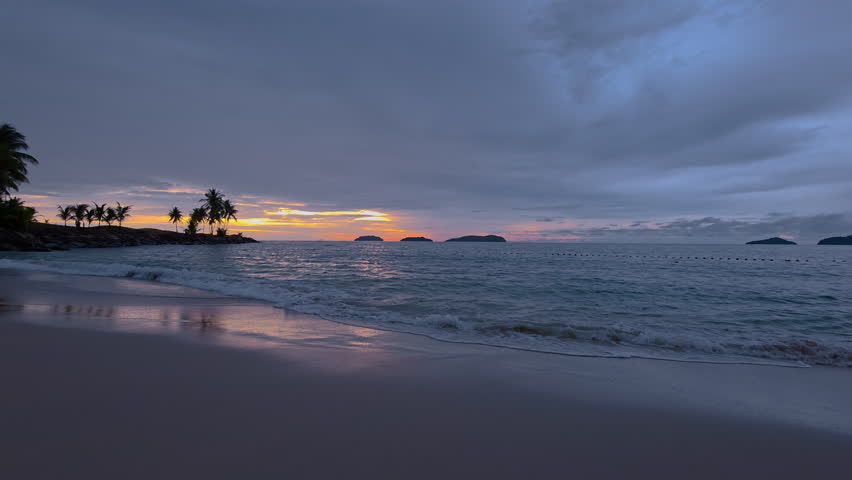 Calm Waves Onto Shores Of Kota Kinabalu Beach Resort During Sunset In Sabah, Malaysia. Wide Shot