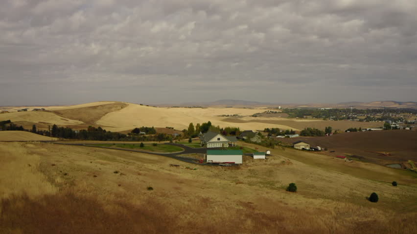 Aerial Upward Scenic Shot Of Houses On Tranquil Hills Under Cloudy Sky - Moscow, Idaho