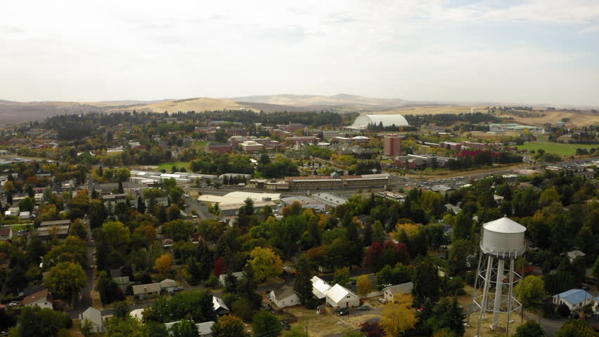 Aerial Forward Scenic Shot Of Storage Tank In Residential Town On Tranquil Hills Under Cloudy Sky - Coeur d`Alene, Idaho
