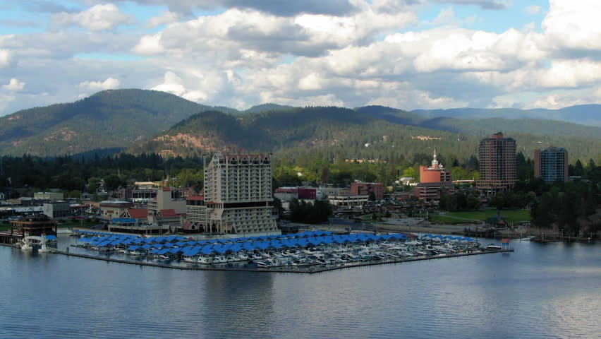 Aerial Zoom Out Shot Of Nautical Vessels At Harbor By 4-Star Hotel In Tranquil Town Under Clouds - Coeur d`Alene, Idaho