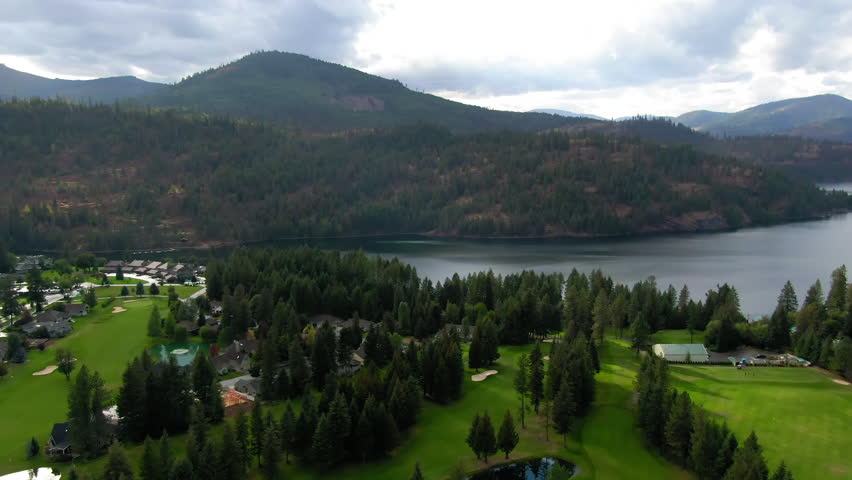 Aerial Scenic View Of Lake By Tranquil Mountains, Drone Flying Backwards Over Green Landscape - Rathdrum, Idaho