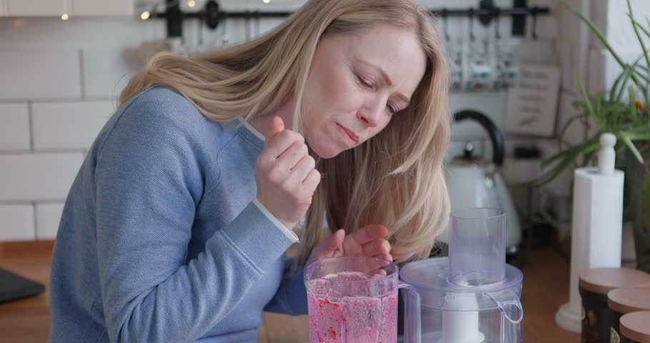 Woman, smoothie and blender in kitchen with detox, fruits and nutrition drink at home. Breakfast, weight loss and female person smile with cooking and nutritionist food in the morning in a house