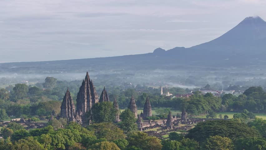 Aerial view of a magnificent Hindu temple with Merapi Mountain on the background, Indonesia.