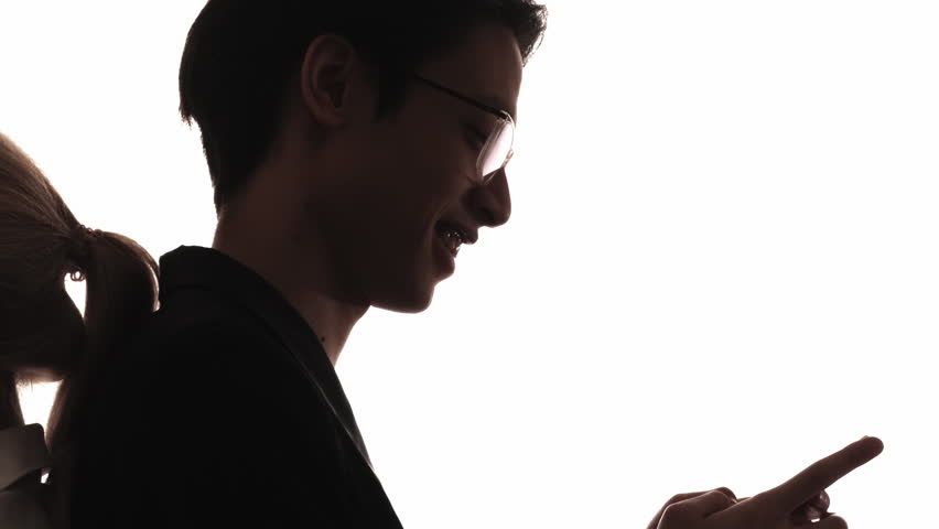 Couple silhouette. Romantic chat. Distance relationship. Dark profile of happy man using phone texting sending online air kiss to girlfriend isolated on white.