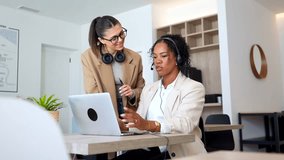 Two customer service representatives collaborate, analyzing data on a laptop and discussing strategies for enhanced customer support - Powered by Shutterstock - Get 15% off with code: PIKWIZARD15