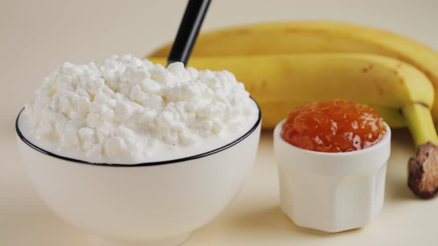 Fresh homemade cottage cheese with jam and banana. Concept of fresh dairy production and healthy alimentation. High quality 4k footage