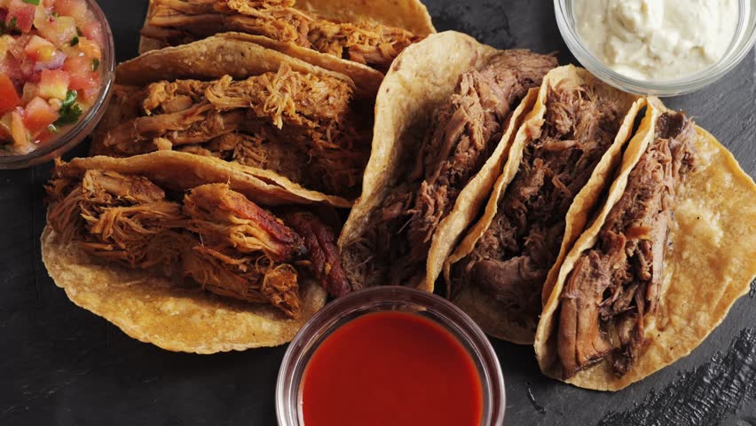 Hand takes aromatic tasty taco with stewed beef and beans. Mexican cuisine concept. High quality 4k footage