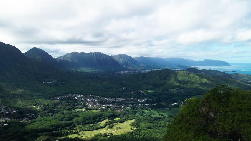 Aerial Idyllic Shot Of Green Tranquil Island By Sea Under Cloudy Sky, Drone Flying Forward On Sunny Day - Honolulu, Hawaii