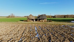 Aerial shot of decaying wooden sheds in a vibrant springtime Latvian countryside - Powered by Shutterstock - Get 15% off with code: PIKWIZARD15