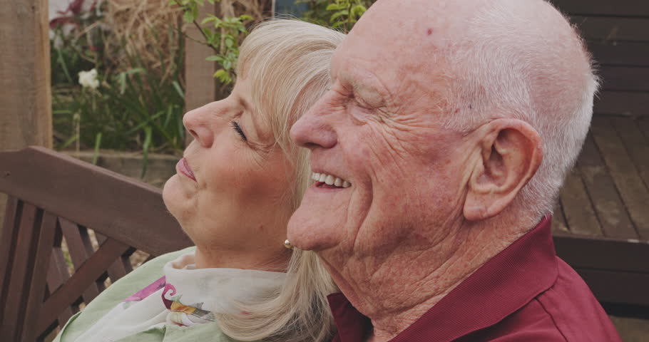 Garden, relax and happy senior couple outdoors for bonding, quality time and laugh at jokes together. Retirement, marriage and elderly man and woman in backyard smile, laughing and talking at home