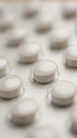 Pills arranged neatly on a surface in a medical context