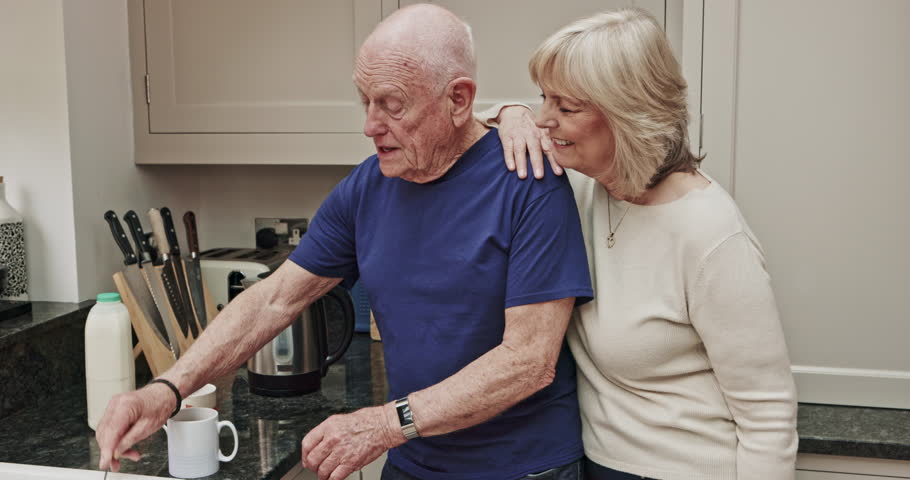 Happy, coffee and love with old couple in kitchen for morning routine, relax and happiness. Smile, bonding and affectionate with senior man and woman with milk at home for tea, drinking and care