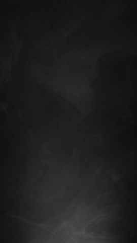 Abstract smoke texture over black background. Fog in the darkness.