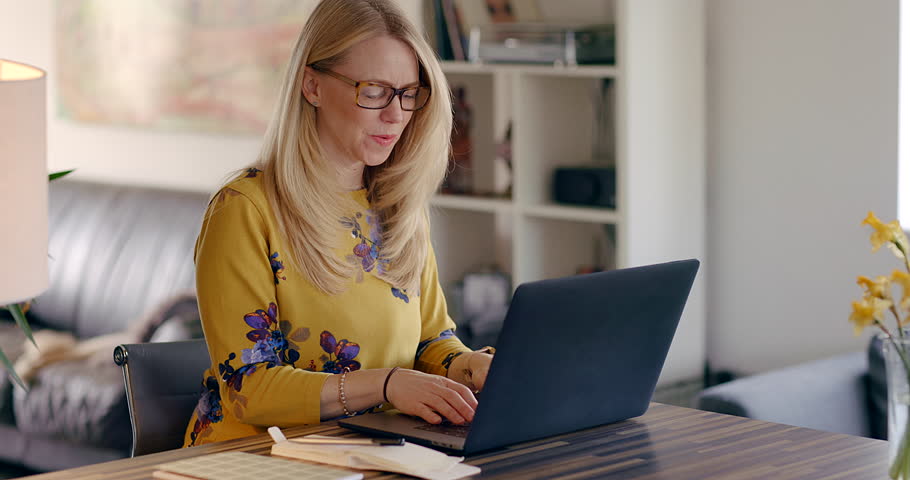 Laughing, laptop and search with woman in home office for freelancer, remote work and website. Business, communication and internet with female typing for email, networking and online administration