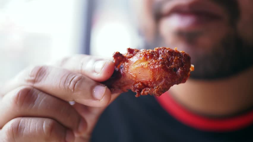 Enjoying spicy chicken wings at a local eatery in the afternoon