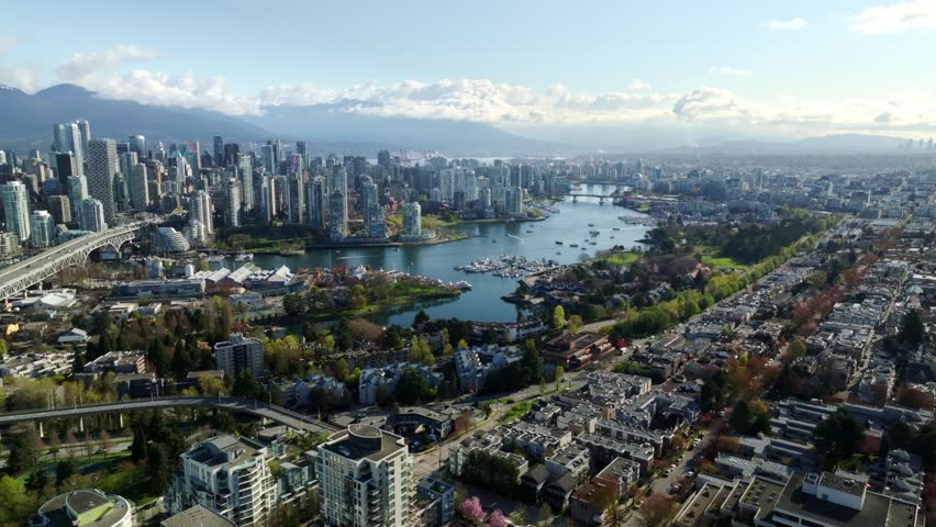 An Elevated Cityscape With Bridges, Boats, and High-rises as Seen From South Granville in Downtown Vancouver, Canada - Wide Shot