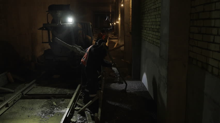 Experienced workers diligently work in tunnel of metro new line. Reinforced concrete ensures stability for years of safe underground transit