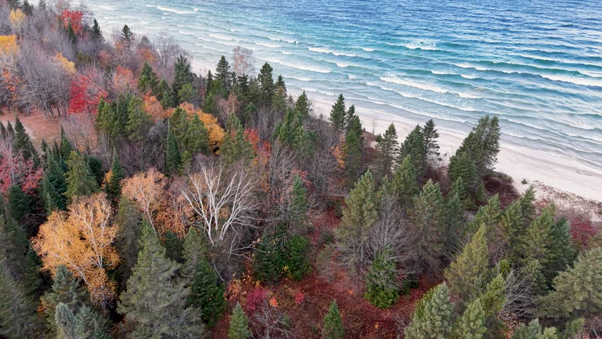 Autumn trees meet the shoreline of Lake Superior in this colorful aerial view from Michigan’s Upper Peninsula