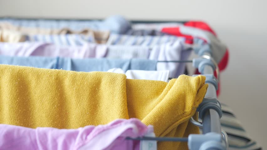 Drying colorful laundry on a rack indoors after washing clothes