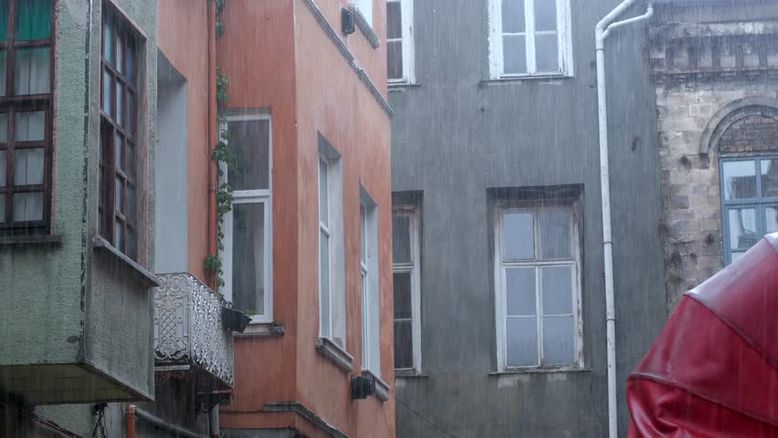Rainy afternoon in a vibrant city street with colorful buildings