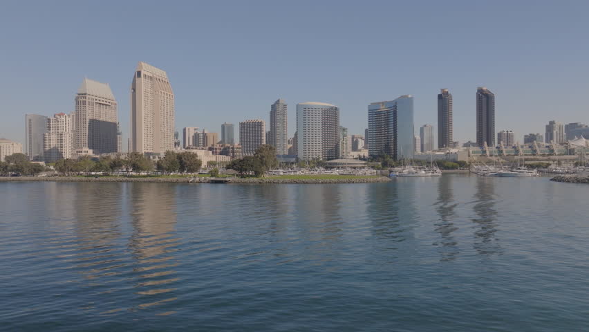Aerial: Drone Panning Beautiful Shot Of Modern Buildings In City Against Clear Sky On Sunny Day - San Diego, California