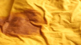 Stains on vibrant yellow cloth in natural light - Powered by Shutterstock - Get 15% off with code: PIKWIZARD15