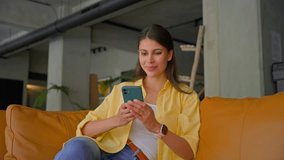 Smiling young indian specialist, female manager using cell phone mobile app for work business chat. Latin hispanic woman working on smartphone in office for shopping or online studying sitting on sofa - Powered by Shutterstock - Get 15% off with code: PIKWIZARD15