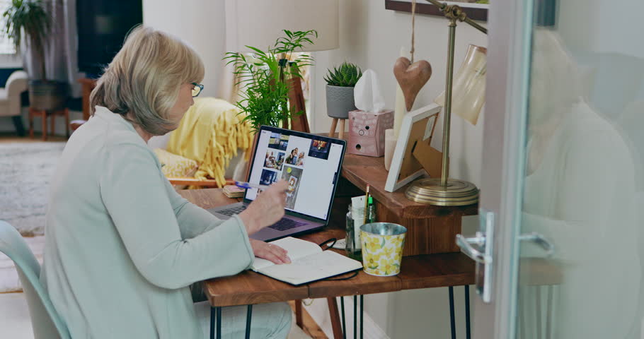 Senior woman, laptop and digital marketing in remote work and writing, strategy or ideas at home office. Elderly female person or creative designer on computer taking notes in book for web research