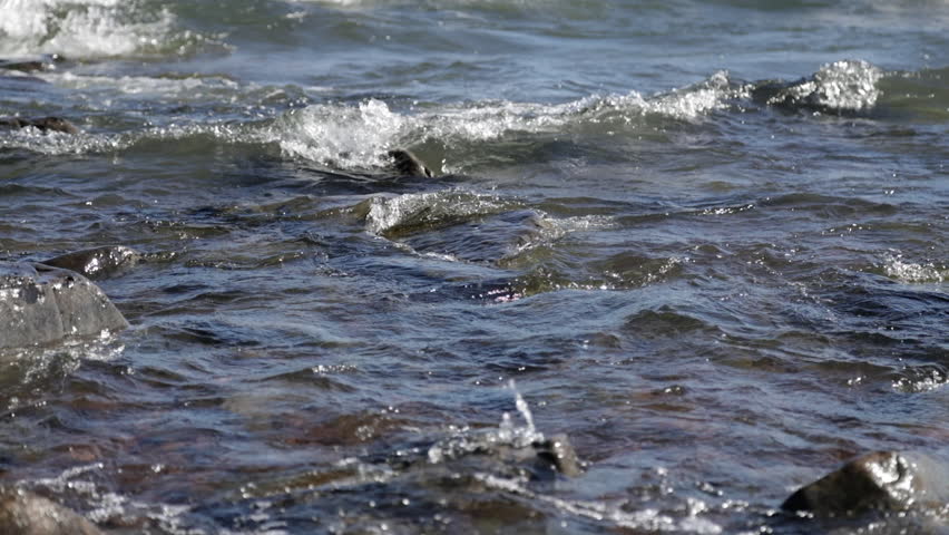 Slow motion waves rolling into rocky shore, Lake Superior, Duluth, Minnesota, United States