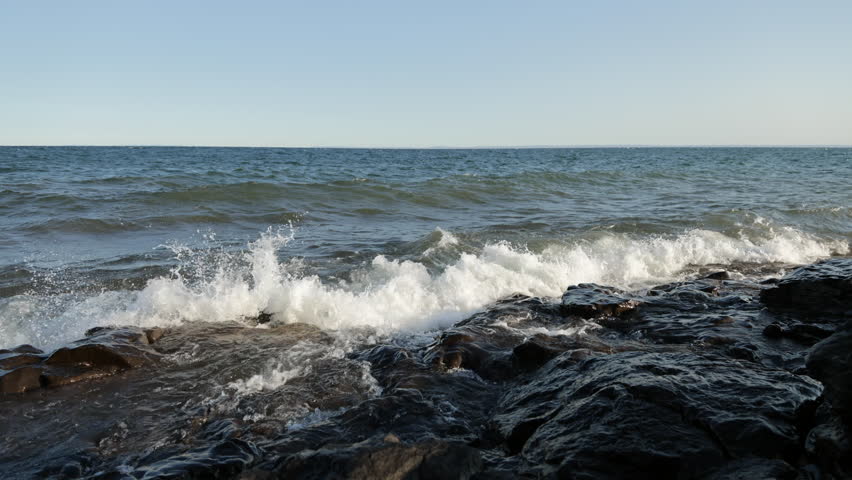 Large waves crashing into rocky beach at sunset, Lake Superior, Duluth, Minnesota, United States, 4K