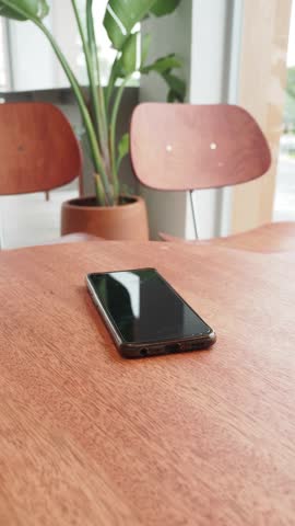 man hand picking up smart phone mobile to receive a call 