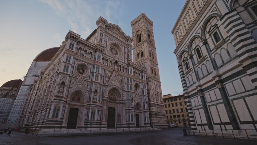 FLORENCE, ITALY - AUGUST 15 2024: Gothic Cathedral of St Mary with flower and Baptistery of Saint John under dusk sky. Amazing medieval religious buildings in old city in evening. Architecture view