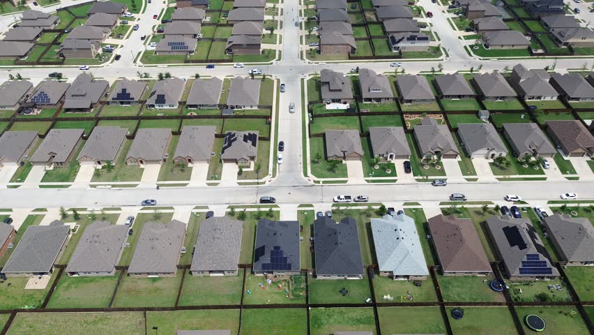 Upscale two-story new construction suburban houses with solar panel roofs in rapid growing Princeton, Collin County, North Texas, clean energy efficiency home suburb DFW metroplex, large backyard. USA