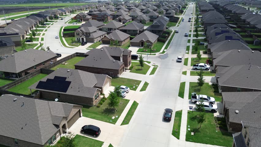 Residential street brand new suburban neighborhood modern houses solar panel roof near construction site foundation prepping, fast growing Princeton, Collin County, Texas, energy efficiency home. USA
