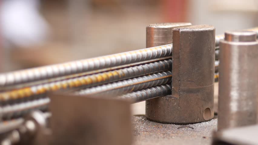 Metalworking with steel rods in a workshop setting