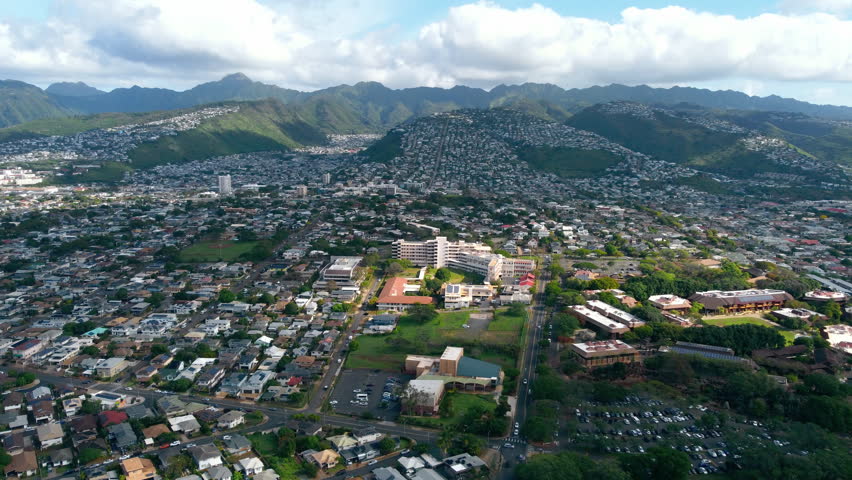 Aerial view of Honolulu residential neighborhoods and green mountains, Hawaii landscape
