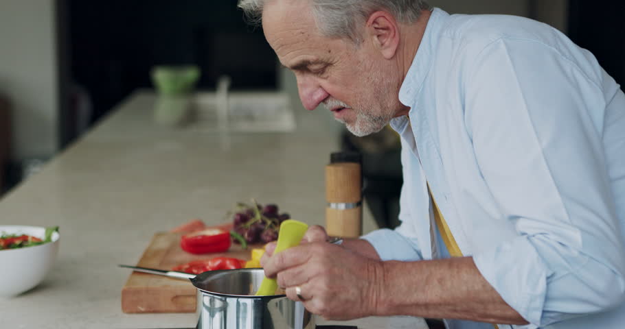 Elderly man, cooking and taste food in the kitchen of house, home and delicious. Senior person, tasting sauce and prepare healthy lunch on the stove, eating meal and nutrition, diet and vegan pot.
