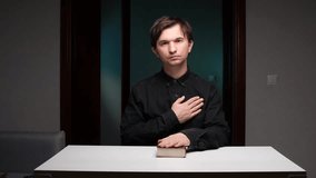 Witness placing hand on chest and holy book, taking an oath - Powered by Shutterstock - Get 15% off with code: PIKWIZARD15
