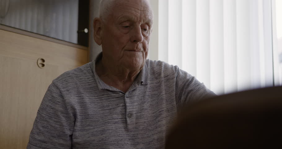 Senior man and wellness health pills at nursing home for self care, supplement and vitamin. Medicine, healthy and elderly retirement person drinking water with medication while thinking.