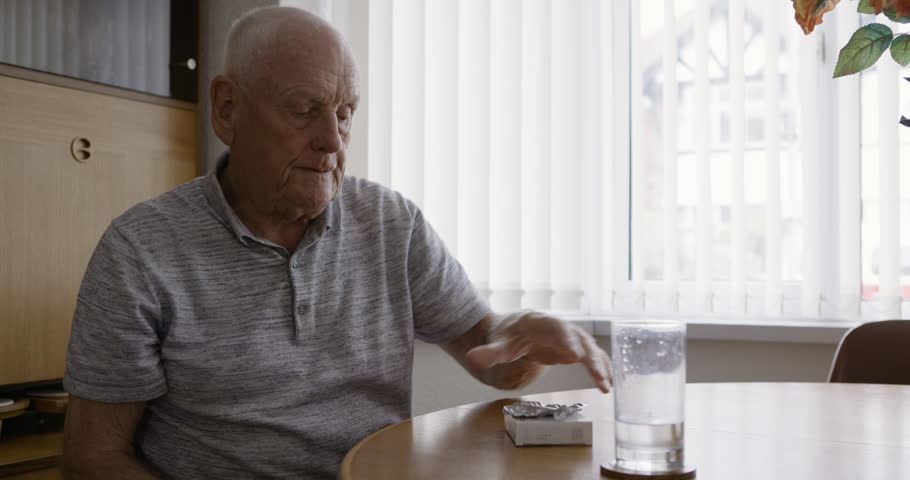 Medicine, pills and senior man drinking water in home for health and wellness in the morning. Vitamins, supplements and retired elderly male from Australia taking tablets for pain, illness or disease