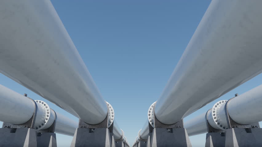 Industrial LNG pipeline system under clear blue sky. Close-up of white gas pipes mounted on concrete supports.