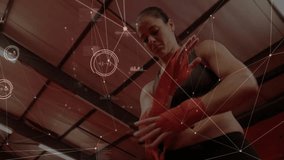 Female athlete wrapping red boxing hand wraps in gym displaying fitness data overlay on metal beams. Fitness, strength, determination, modern, energetic, training, health - Powered by Shutterstock - Get 15% off with code: PIKWIZARD15