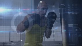 Athletic man delivering punch in modern gym, showing fitness HUD charts and numeric data streams. Fitness, technology, interface, strength, workout, digital, innovation - Powered by Shutterstock - Get 15% off with code: PIKWIZARD15
