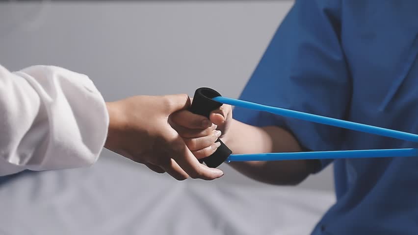 Physical therapist working with patient on upper extremity exerc