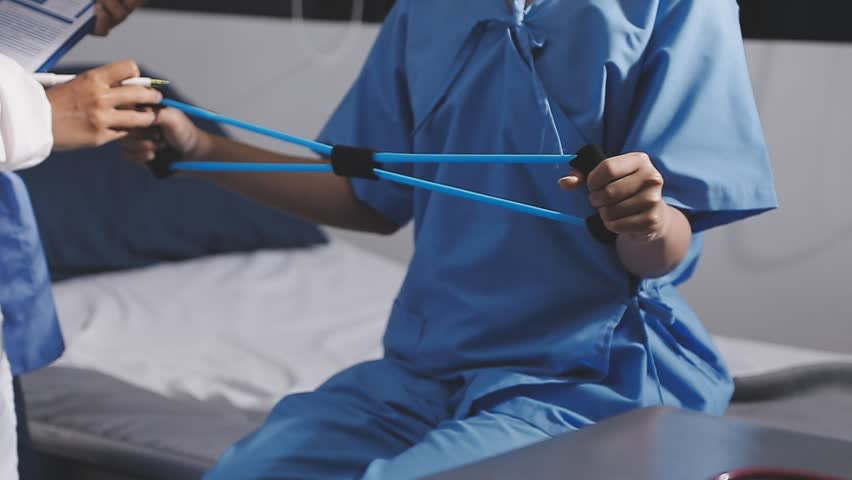 Physical therapist working with patient on upper extremity exerc