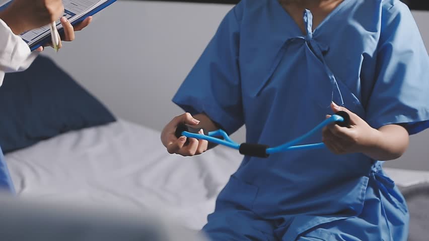 Physical therapist working with patient on upper extremity exerc