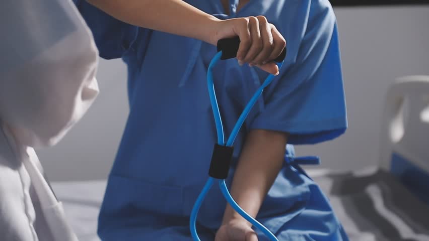 Physical therapist working with patient on upper extremity exerc