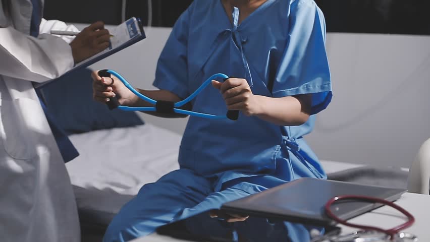 Physical therapist working with patient on upper extremity exerc