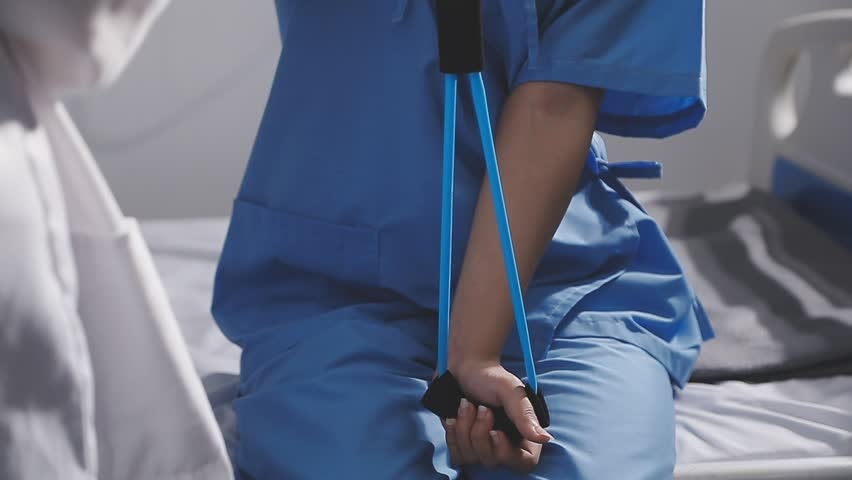 Physical therapist working with patient on upper extremity exerc